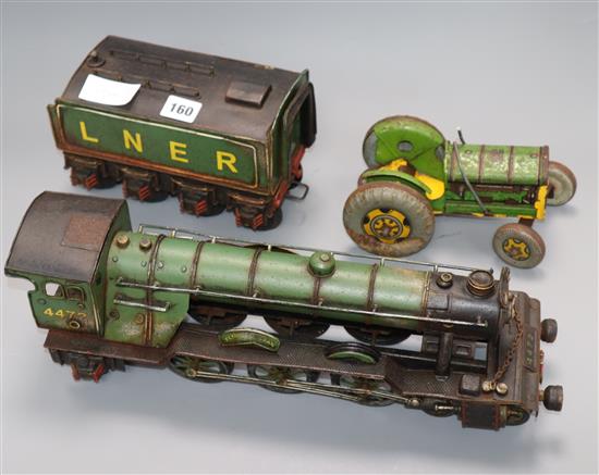 A model locomotive and a tinplate tractor